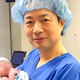 John Zhang with the first baby born through an IVF technique that uses the DNA of three people. The baby was born in April 2016. Image: New Hope Fertility Clinic